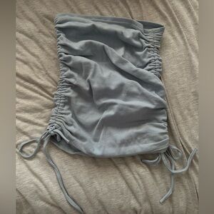 Baby blue ruched mini skirt. Strings make skirt adjustable for length. Size S